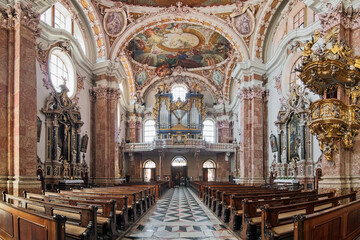 Fototapeta na wymiar Innsbruck, Austria. Panoramic view of interior of Innsbruck Cathedral with main organ. The cathedral was built in 1717-1724.