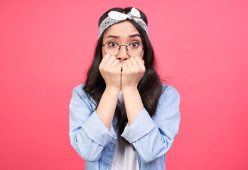 A frightened young Asian girl covered her mouth with her fists.