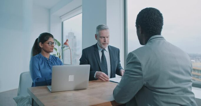 Multi-ethnic couple of hiring managers doing recruit job interview in office
