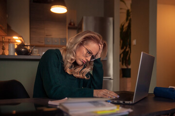 one young woman, clueless how to work late at night on her laptop.