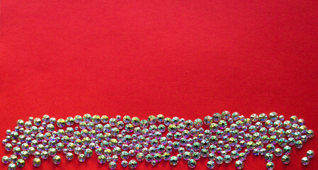 rhinestones on a red background, top photo. design for text