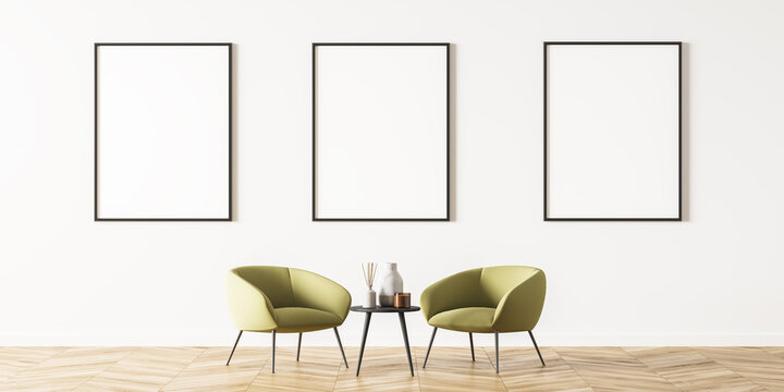 Cosy interior with three posters and green armchairs