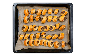Baked pate in dough lying on a tray on baking paper, isolated on a white background with a clipping...