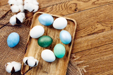 Fototapeta na wymiar painted eggs decoration verbena wooden background top view