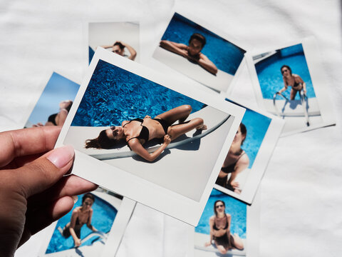 Girl lying on edge of swimming pool in sunlight.