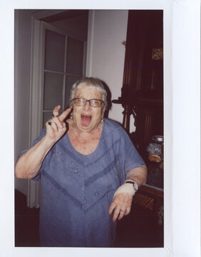 Funny granny having fun at home.