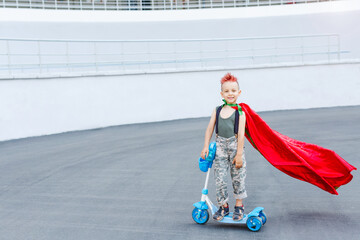 Kid superhero in a red cloak.