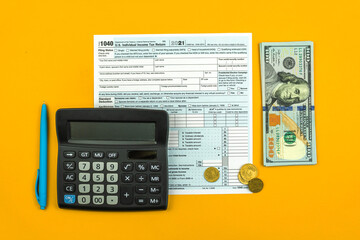 Time to pay taxes concept flat lay background with 1040 tax form and calculator