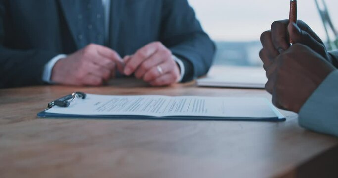 Close up of a busineswoman handing over a contract to a businessman 