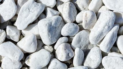 Close-up of light gray pebbles, smooth stones in a wrap-up plan as a background or wallpaper