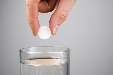 aspirin tablet in glass of water