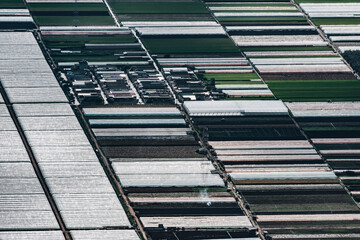 aerial view of agricultural plots of land under cultivation in an agricultural town.