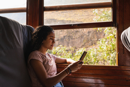 Girl with braids look at the mobile