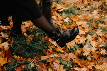 Female autumn leather boots with chains