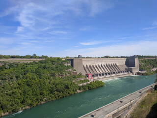 Robert Moses Niagara Hydroelectric Power Station shot from Canada. Hydropower - largest source of green energy. Summer day, blue sky. Replenishable green renewable energy and natural sources concept.