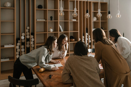 Inspired female team creating handicraft design in office