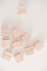 Stack wooden blocks from natural wood on a white background. Top view. Copy, empty space for text