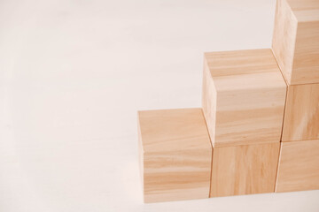 Stack wooden blocks from natural wood on a white background. Copy, empty space for text