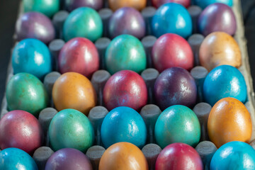 Easter background with hand painted purple, blue, green, orange