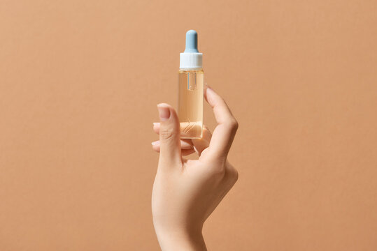 medical bottle in hand isolated on yellow background