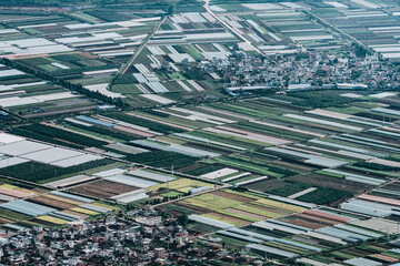 aerial view of agricultural plots of land under cultivation in an agricultural town.