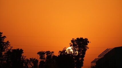 The beautiful sunset view with the warm sun downing in the sky