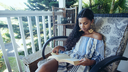 Woman reading book on deck