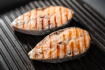 Salmon fillets in frying pan