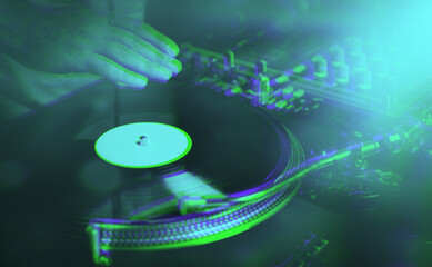 Abstract background with hip hop disc jockey scratching vinyl records on turntables in night club. Professional dj scratches vinyl on turn table on concert stage edited with 3d anaglyph effect