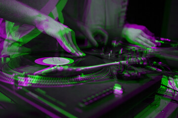 Abstract background with hip hop dj scratching vinyl records on turntable in night club edited with...