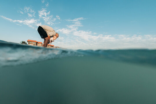 Man holding granddaughter at beach