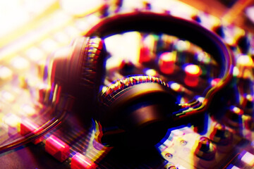 Professional dj headphones on sound mixer panel.Disc jockey audio equipment on stage in nightclub