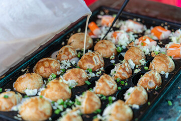 Coconut rice balls is traditional Thai dessert made from rice flour and coconut milk at street food market in Thailand