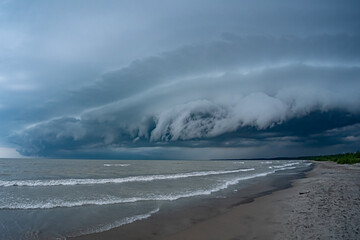 Heavy dark thunderstorm clouds over Lake Erie seascape. Severe weather, hurricane, heavy rain,...
