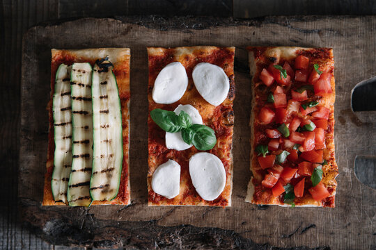 Homemade Pizza With Different Toppings On Wooden Board