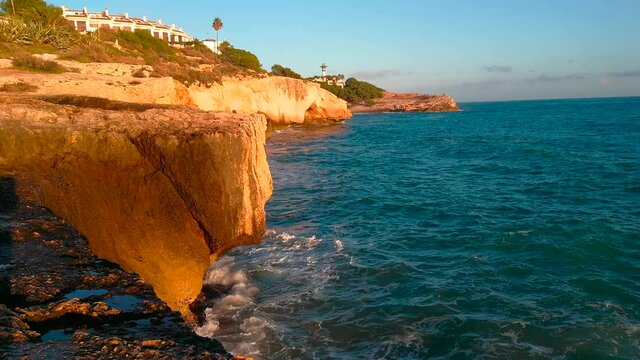 Tarragona coast with the sea and the Torredembarra Lighthouse at sunset