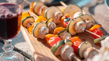 Vegetarian skewer of zucchini, tomato and sweet pepper on a wooden skewer