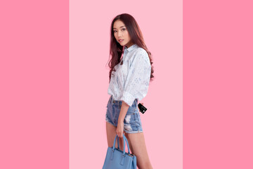 Young asian model woman holding card and carrying pastel color blue handbag in shopping online Concept.