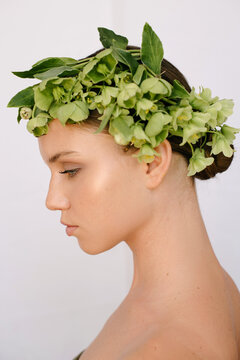 Sensual portrait of a young blue-eye's girl with flowers covering her head