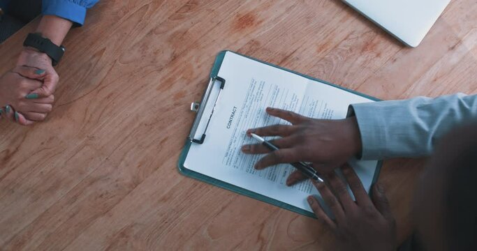 Close up of a busineswoman handing over a contract to a businessman 