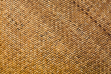 Textured background in the form of weaving from straw material. Horizontal image.