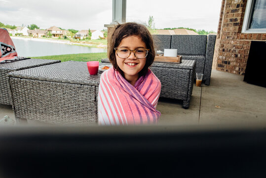 Young girl smiling over computer.