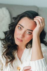 Fototapeta premium Close up beautiful cozy home portrait of a young beautiful curly woman. Spring. Fashion.