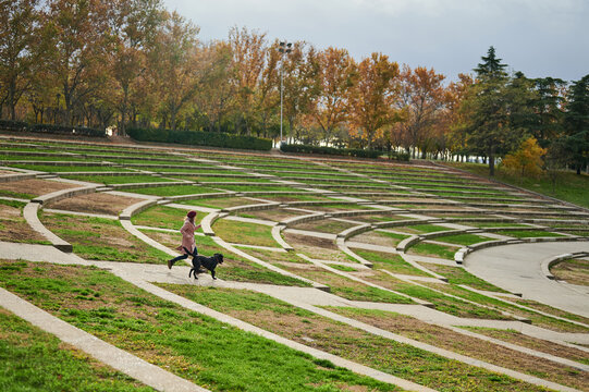 Girl running with dog in park