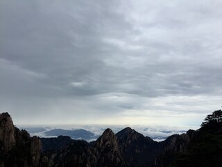 China Mount HuangShan - April, 2015: Natural scenery, sunsets, peculiarly-shaped granite peaks, Huangshan pine trees and views of the clouds from above. Photo taken in Yellow Mountain (UNESCO).