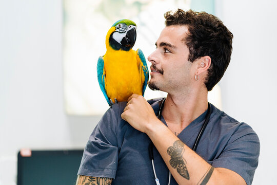 Portrait of Happy Vet With Parrot