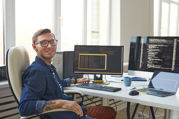 Portrait of IT Programmer Using Computers with Code on Screen - obrazy, fototapety, plakaty