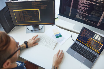 IT Programmer Using Computers with Code on Screen
