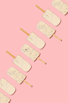 Vanilla ice pops on pastel pink