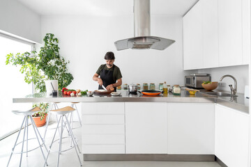 Man cutting onion in the kitchen